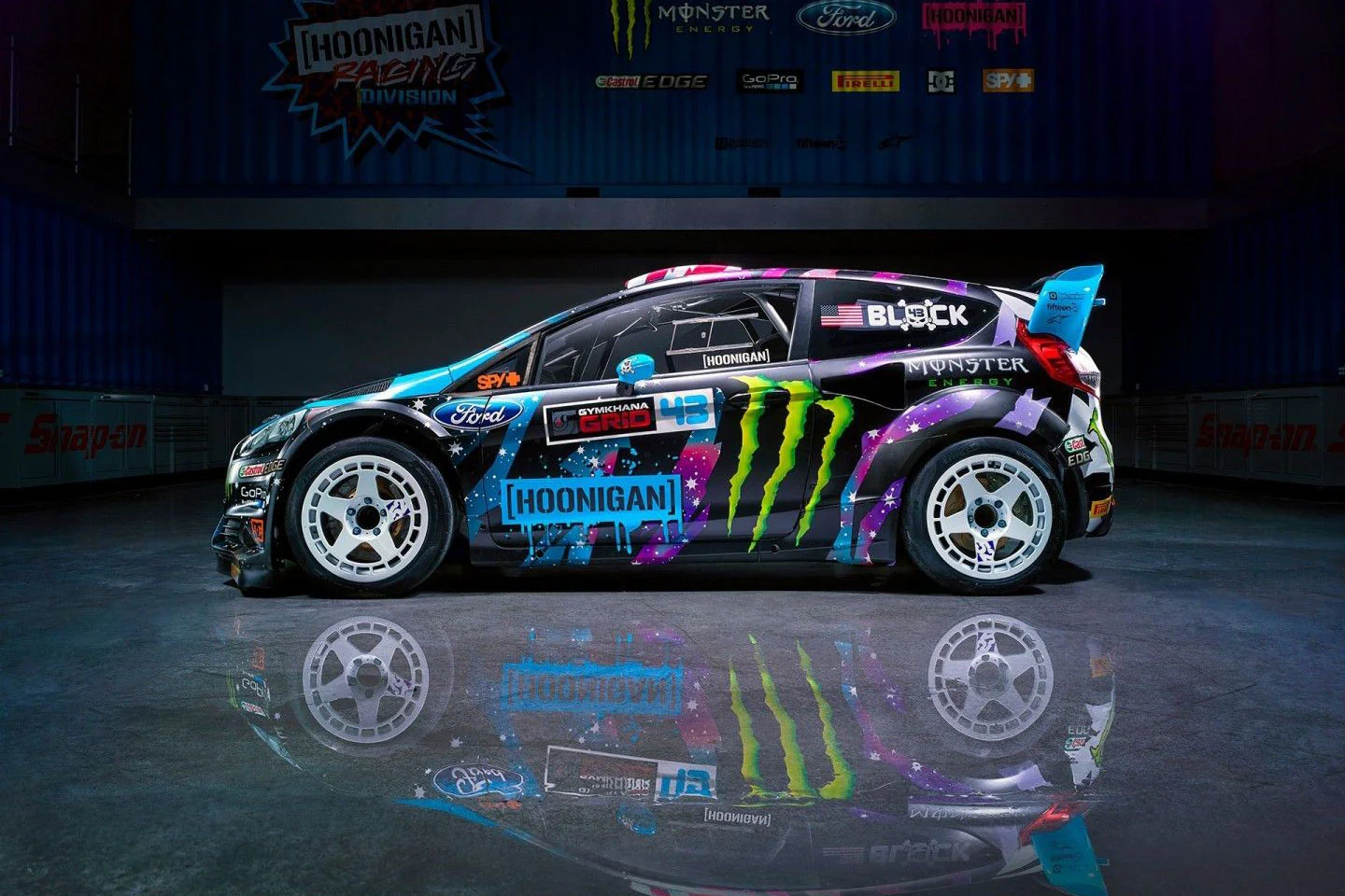 Ken Block’s rally car with a colorful graphic livery photographed in profile.